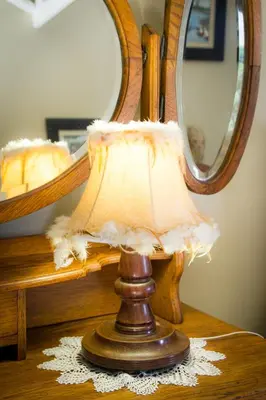 a lamp sitting on a table in front of a mirror at De Zoete Rust Guesthouse in Centurion