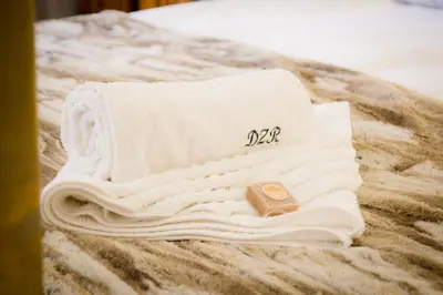 a pile of towels sitting on top of a bed at De Zoete Rust Guesthouse in Centurion