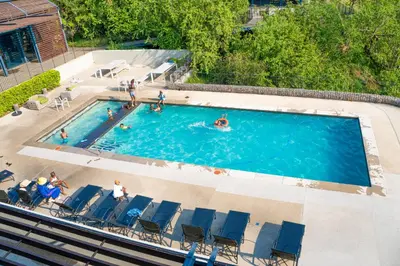 an overhead view of a swimming pool with people in it at Secure 1 Bedroom Apartment in Midrand, Waterfall City - Lock Up and Go - Free WIFI and Parking - 5 Elizabeth Place in Midrand