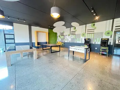 a room with two tables and a ping pong table at Secure 1 Bedroom Apartment in Midrand, Waterfall City - Lock Up and Go - Free WIFI and Parking - 7 Elizabeth Place in Midrand