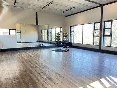 an empty room with a wooden floor and windows at Spacious 2 Bedroom Apartment in Midrand, Waterfall City - Business and Family friendly - 12 Elizabeth Place in Midrand