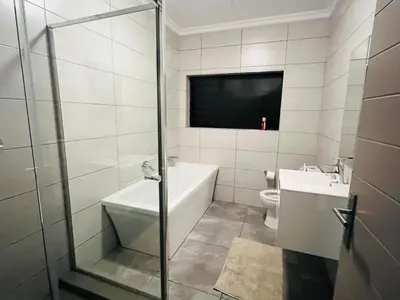 a bathroom with a tub and a toilet and a television at Spacious 2 Bedroom Apartment in Midrand, Waterfall City - Business and Family friendly - 12 Elizabeth Place in Midrand