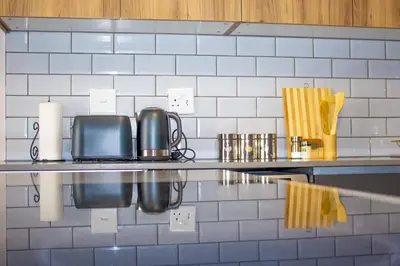 a kitchen with a counter top with a toaster and a microwave at Spacious 2 Bedroom Apartment in Midrand, Waterfall City - Business and Family friendly - 10 Elizabeth Place in Midrand