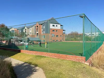 a tennis court with people playing tennis on a court at Spacious 2 Bedroom Apartment in Midrand, Waterfall City - Business and Family friendly - 10 Elizabeth Place in Midrand
