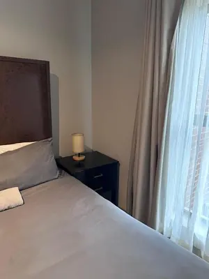 a bedroom with a bed next to a window at Large 3 Bedroom Apartment in Midrand, Waterfall City - More space than a hotel room - Ideal for families, groups and work trips - 15 Elizabeth Place in Midrand