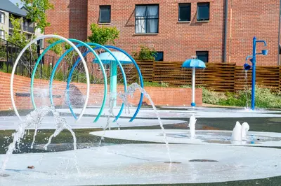 a group of water fountains in front of a building at Large 3 Bedroom Apartment in Midrand, Waterfall City - More space than a hotel room - Ideal for families, groups and work trips - 15 Elizabeth Place in Midrand