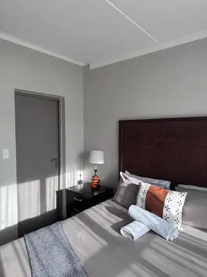 a bedroom with a bed with two towels on it at Large 3 Bedroom Apartment in Midrand, Waterfall City - More space than a hotel room - Ideal for families, groups and work trips - 15 Elizabeth Place in Midrand