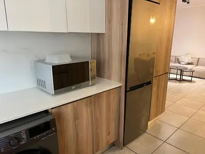 a kitchen with a microwave on top of a counter at Large 3 Bedroom Apartment in Midrand, Waterfall City - More space than a hotel room - Ideal for families, groups and work trips - 17 Elizabeth Place in Midrand