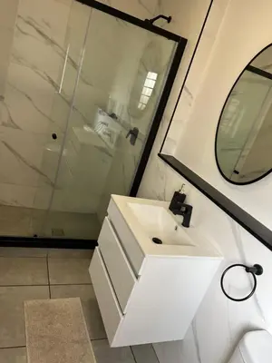 a bathroom with a white sink and a shower at Large 3 Bedroom Apartment in Midrand, Waterfall City - More space than a hotel room - Ideal for families, groups and work trips - 17 Elizabeth Place in Midrand