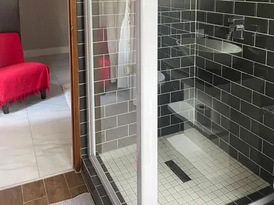 a glass shower door with a sink in a bathroom at Oaktree in Ermelo