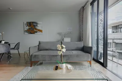 a living room with a couch and a table at Elipse Waterfall-2803 in Midrand