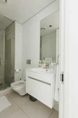 a bathroom with a toilet and a sink and a mirror at Elipse Waterfall-2803 in Midrand