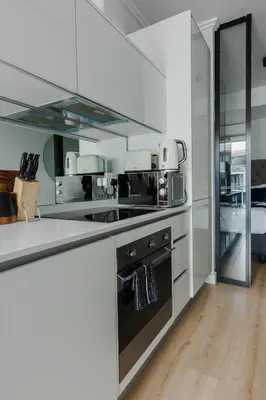 a kitchen with white counters and a stove top oven at Elipse Waterfall-2803 in Midrand