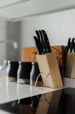 a block of knives sitting on top of a counter at Elipse Waterfall-2803 in Midrand