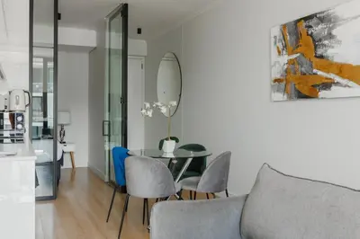 a living room with a table and chairs at Elipse Waterfall-2803 in Midrand