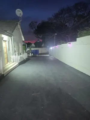 an empty parking lot at night with a basketball hoop at The wood Guest house in Pretoria