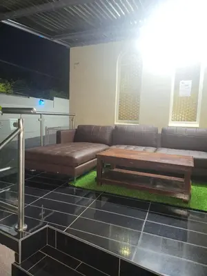 a living room with a couch and a table at The wood Guest house in Pretoria