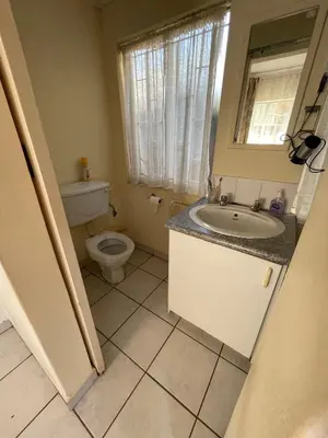 a bathroom with a sink and a toilet at Smartshelter Park in Pretoria