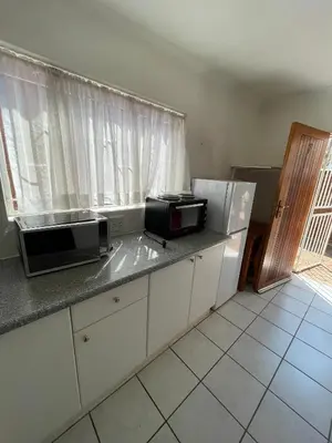 a kitchen with a counter with a microwave and appliances at Smartshelter Park in Pretoria