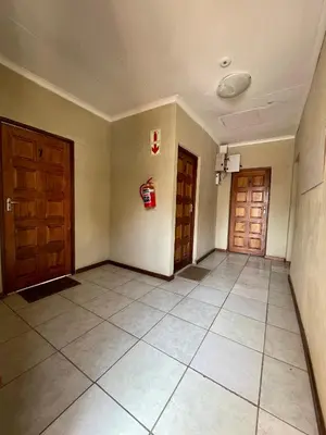 an empty room with two doors and a tile floor at Smartshelter Park in Pretoria