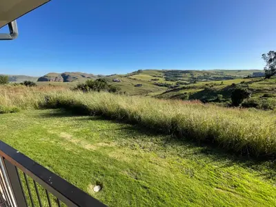 a view of the hills from the balcony of a house at Highland Gate Eagles Breeze in Dullstroom