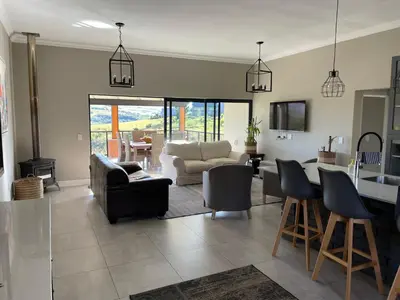 a living room with a couch and chairs and a table at Highland Gate Eagles Breeze in Dullstroom