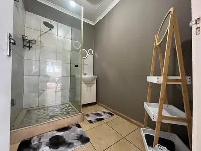 a bathroom with a shower and a glass shower stall at 1 on Titania in Polokwane