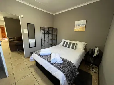 a bedroom with a bed with two towels on it at 1 on Titania in Polokwane