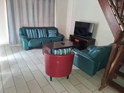 a living room with a couch and a coffee table at Kruger Nest in Marloth Park