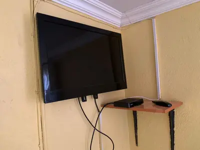 a flat screen tv hanging on a wall at Bobirwa Resort & Accomodation in Polokwane