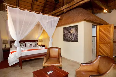 a bedroom with a bed with a net canopy at Kubu Safari Lodge in Hoedspruit
