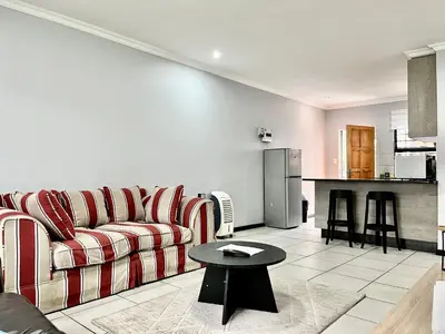 a living room with a couch and a table at Comfort in Glen Austin, Midrand in Midrand