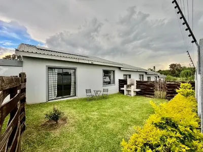 a white house with a fence and a yard at Comfort in Glen Austin, Midrand in Midrand