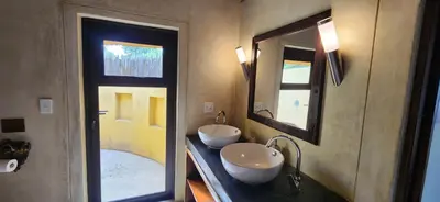 a bathroom with two sinks and a large mirror at Heartland Self-catering Accommodation in Kampersrus AH