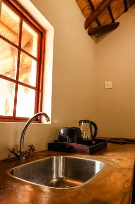 a kitchen counter with a sink and a window at Bushvilla's Silonque in Phalaborwa