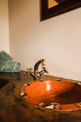 a bathroom with a wooden sink with a faucet at Bushvilla's Silonque in Phalaborwa