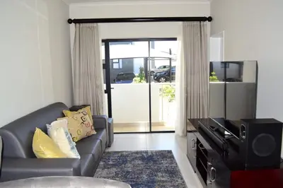 a living room with a couch and a tv at Soldout Camp 1 in Johannesburg