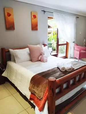 a bedroom with a bed with a teddy bear on it at Betel in White River