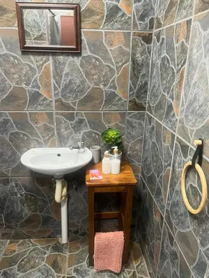 a bathroom with a sink and a wooden table at Betel in White River