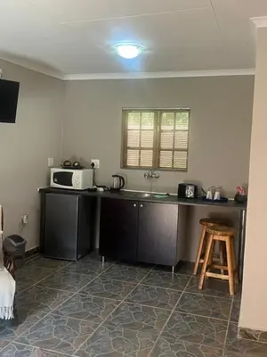 a kitchen with a counter top with a microwave at Betel in White River