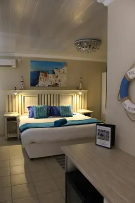 a bedroom with a large bed in a room at El Gran Chaparral Guest House in Pretoria