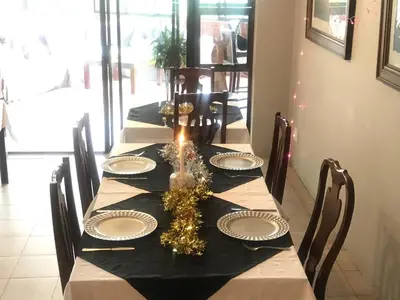 a dining room table with a black and white table cloth at Edelweiss Corporate Guest House in Pretoria