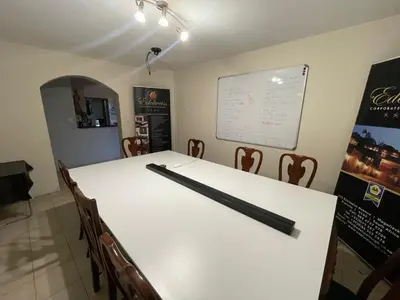 a conference room with a white table and chairs at Edelweiss Corporate Guest House in Pretoria