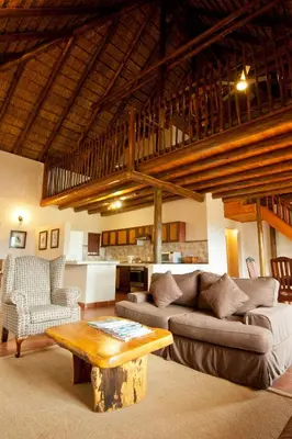 a living room with a couch and a table at Amafu Forest Lodge in Hoedspruit
