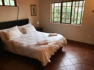 a bedroom with a bed with two towels on it at Amafu Forest Lodge in Hoedspruit
