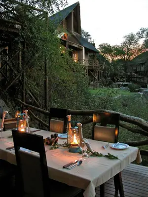 a table with lights on it sitting on a deck at Lukimbi Safari Lodge in Malelane