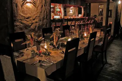 a dining room with a long table and chairs at Lukimbi Safari Lodge in Malelane