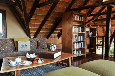 a living room with a couch and a table at Lukimbi Safari Lodge in Malelane