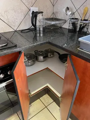 an open drawer in a kitchen with pots and pans at Thorntree Self Catering Apartment, Witbank in Witbank