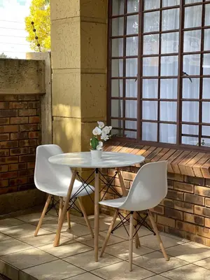 a table and two chairs on a patio at Thorntree Self Catering Apartment, Witbank in Witbank